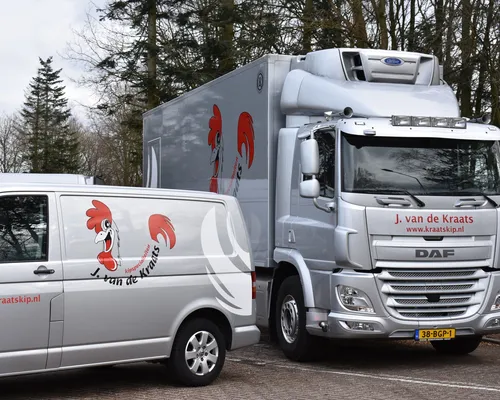 J. van de Kraats company van next to a truck